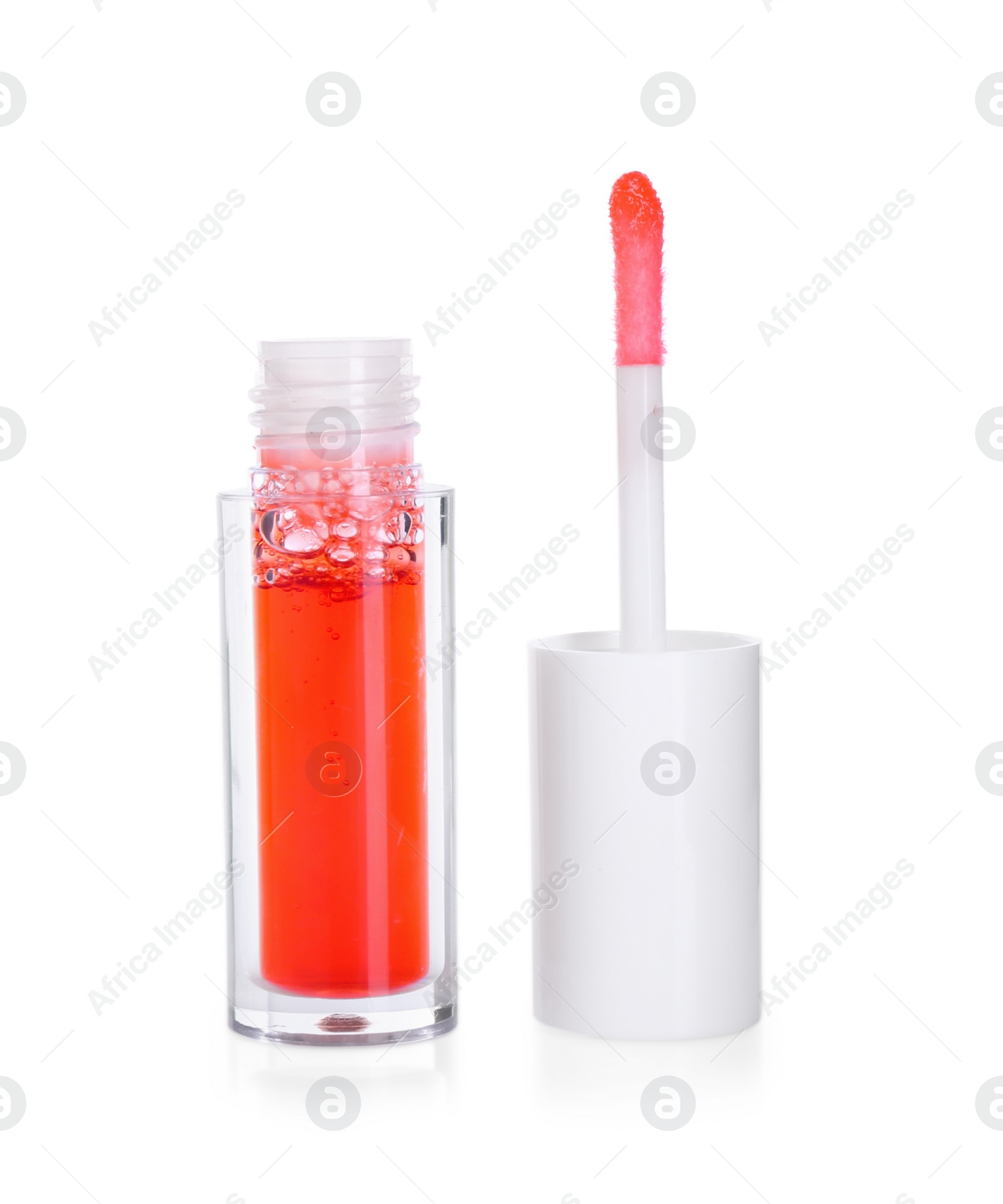 Photo of Bright lip gloss and applicator isolated on white. Cosmetic product