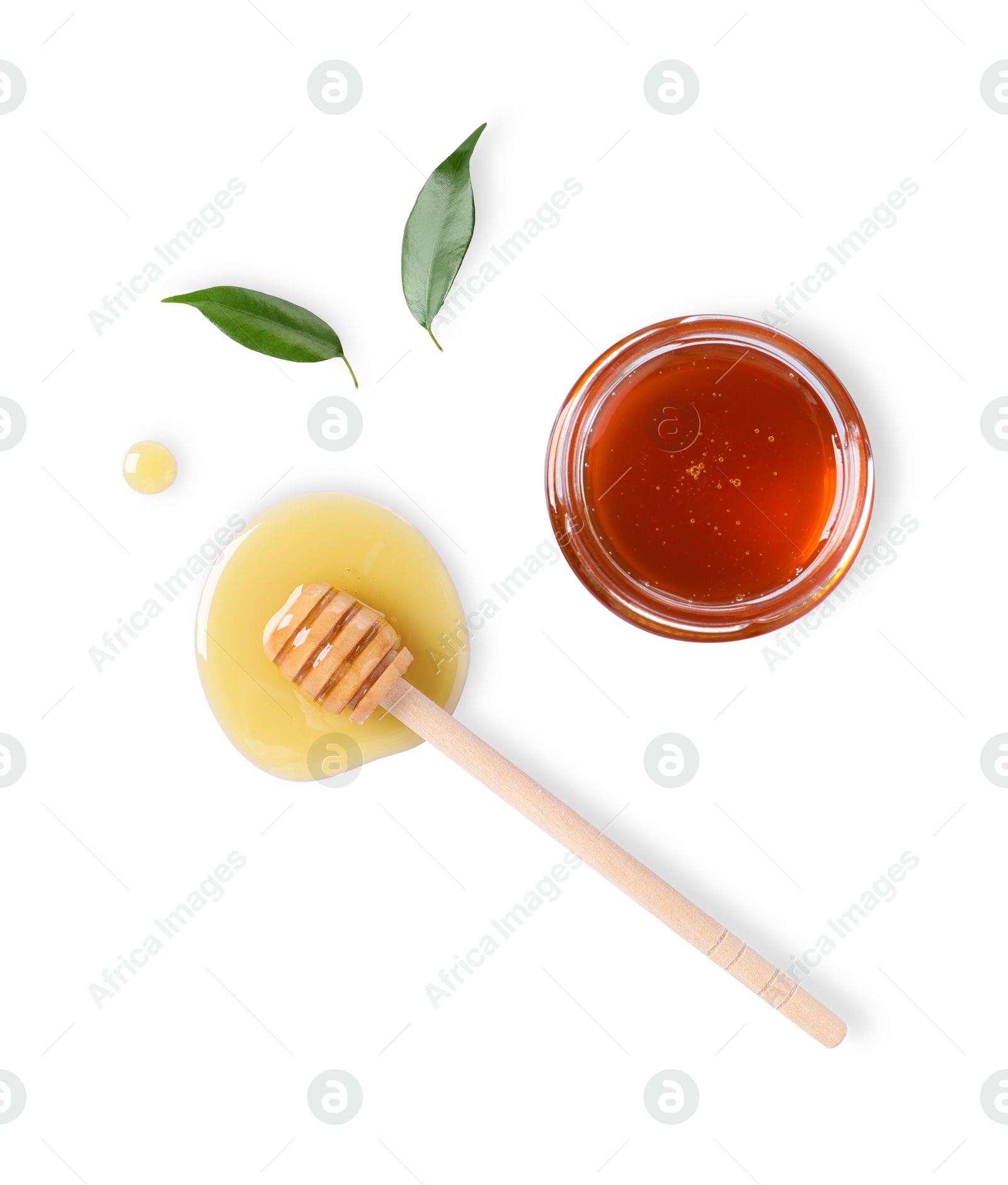 Photo of Tasty natural honey, glass jar, dipper and green leaves on white background, top view