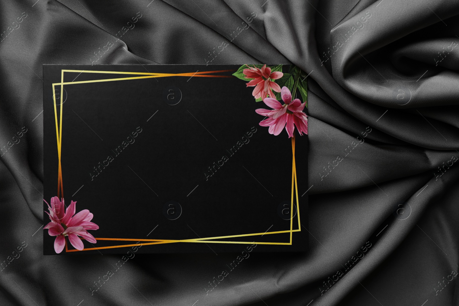 Photo of Blank invitation card on black fabric, top view. Space for text