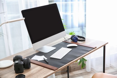 Photo of Light modern interior of working place with computer