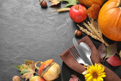 Photo of Autumn fruits, vegetables and cutlery on grey background, space for text. Happy Thanksgiving day