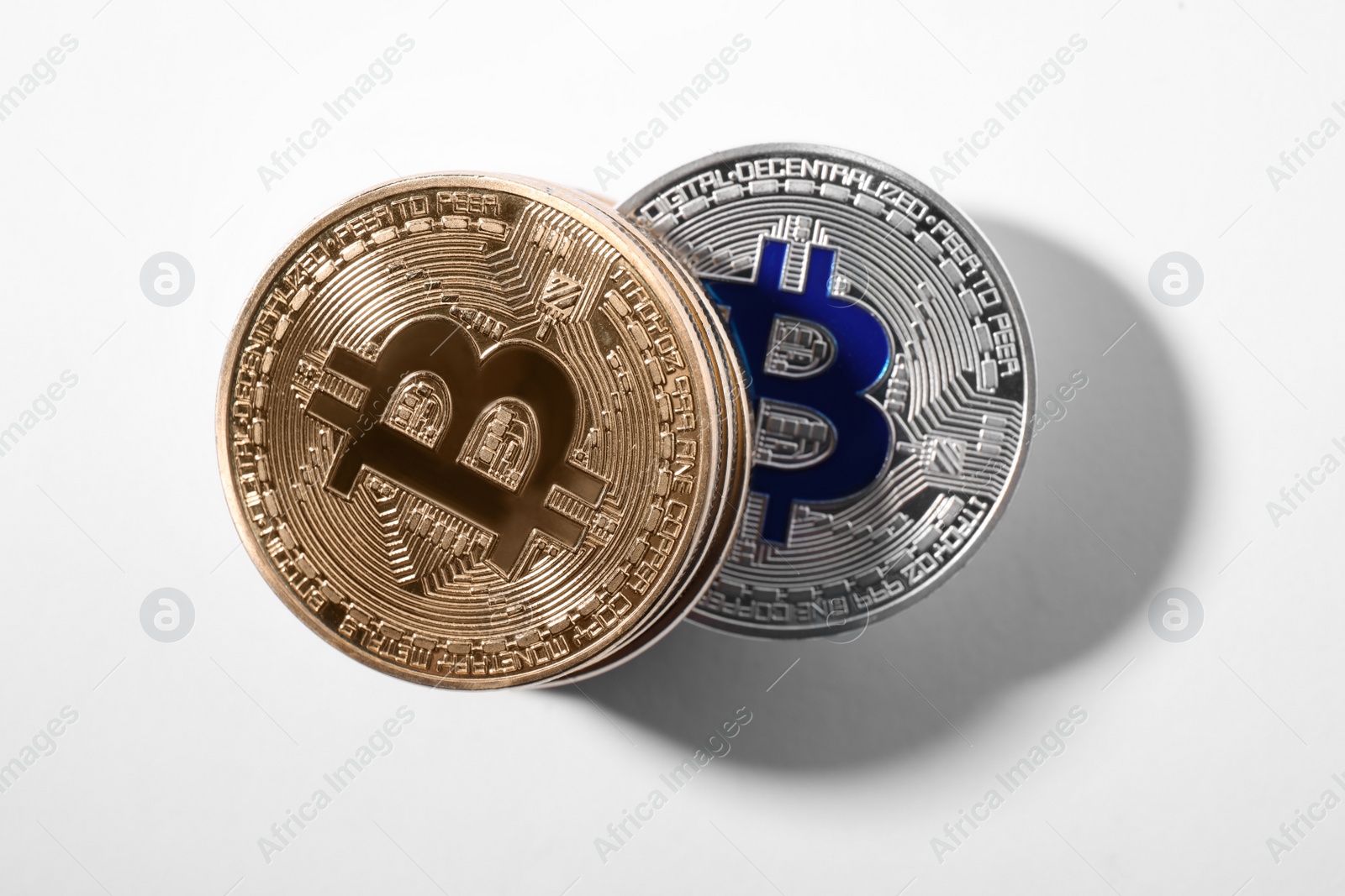 Photo of Golden and silver bitcoins on white background, top view. Digital currency