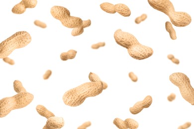 Image of Unpeeled peanuts in air on white background