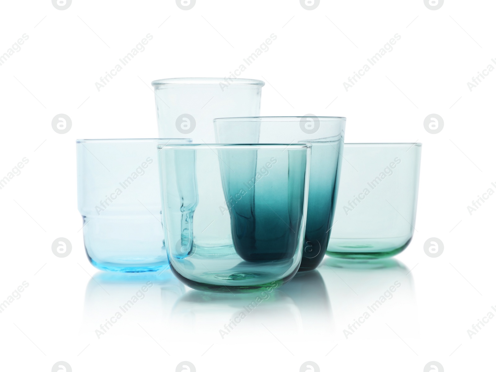 Photo of Set of colorful empty glasses on white background