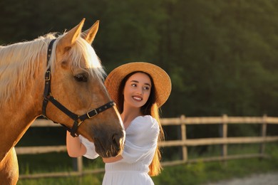 Photo of Woman with adorable horse outdoors. Lovely domesticated pet