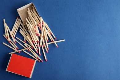 Photo of Flat lay composition with matches and space for text on color background
