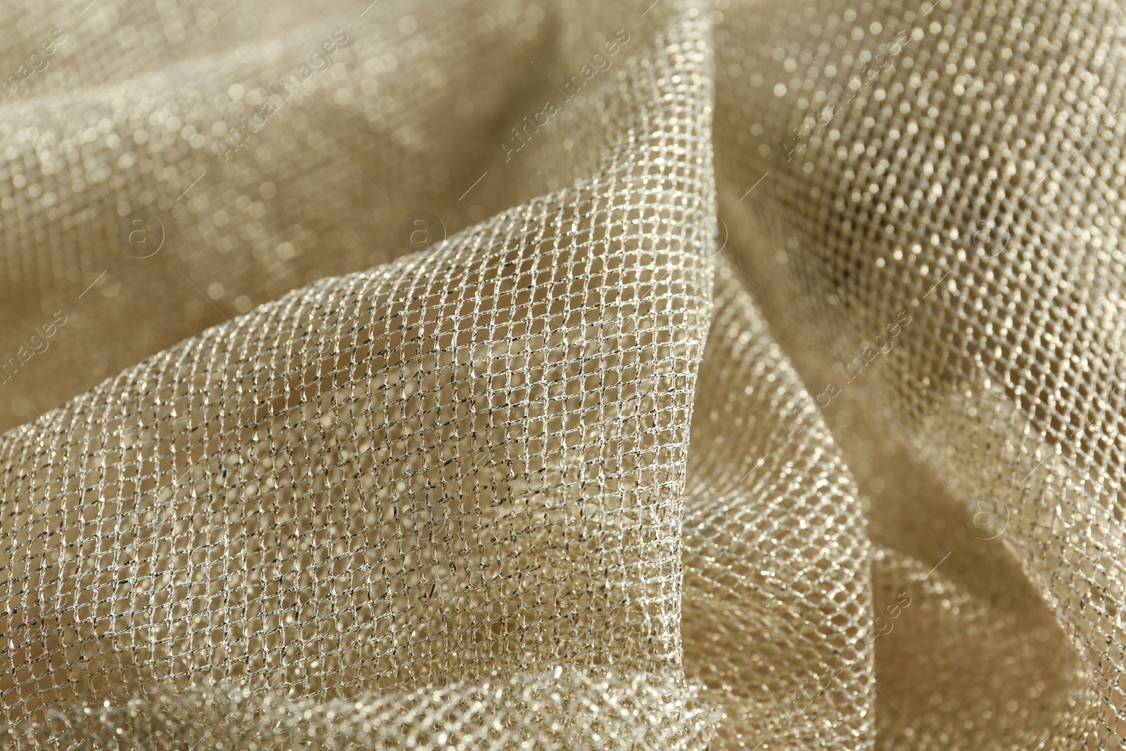 Photo of Texture of golden net fabric as background, closeup