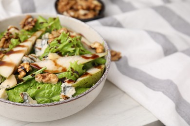 Delicious pear salad with sauce in bowl on white table, closeup. Space for text