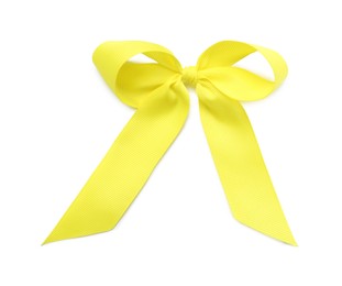 Yellow ribbon bow on white background, top view