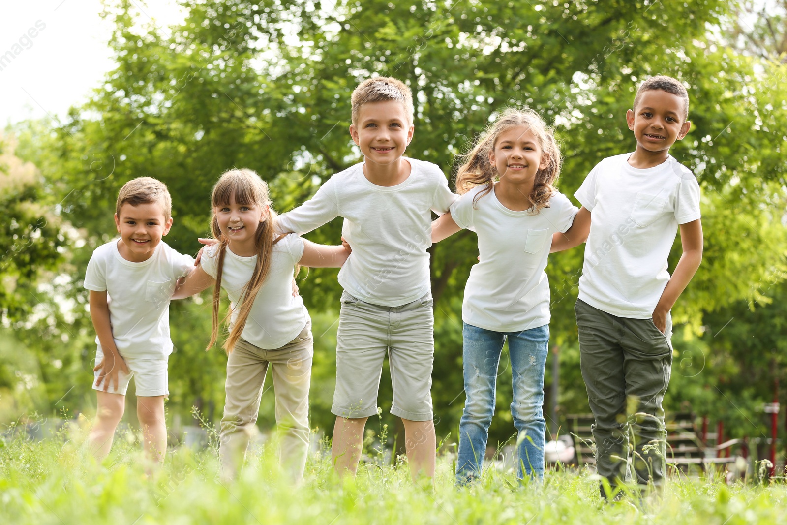 Photo of Group of children huddling in park. Volunteer project