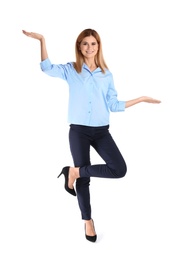 Full length portrait of businesswoman balancing on white background