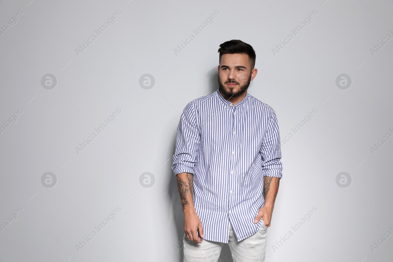 Photo of Portrait of handsome young man against light background