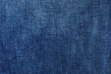 Photo of Texture of dark blue jeans as background, closeup