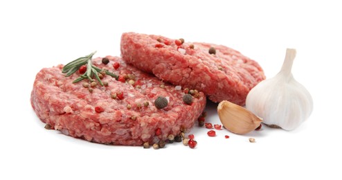 Photo of Raw hamburger patties with rosemary, garlic and spices on white background, closeup