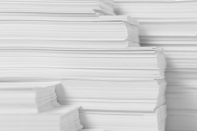 Photo of Stacks of paper sheets as background, closeup