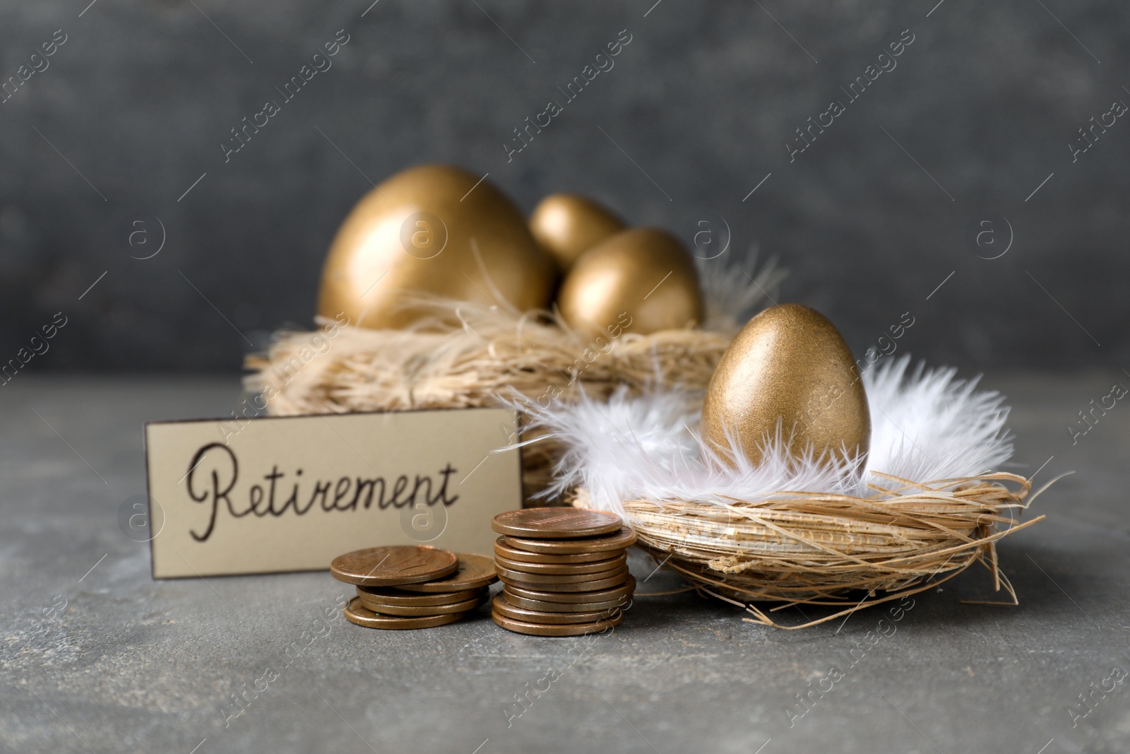 Photo of Many golden eggs, coins and card with word Retirement on grey table. Pension concept