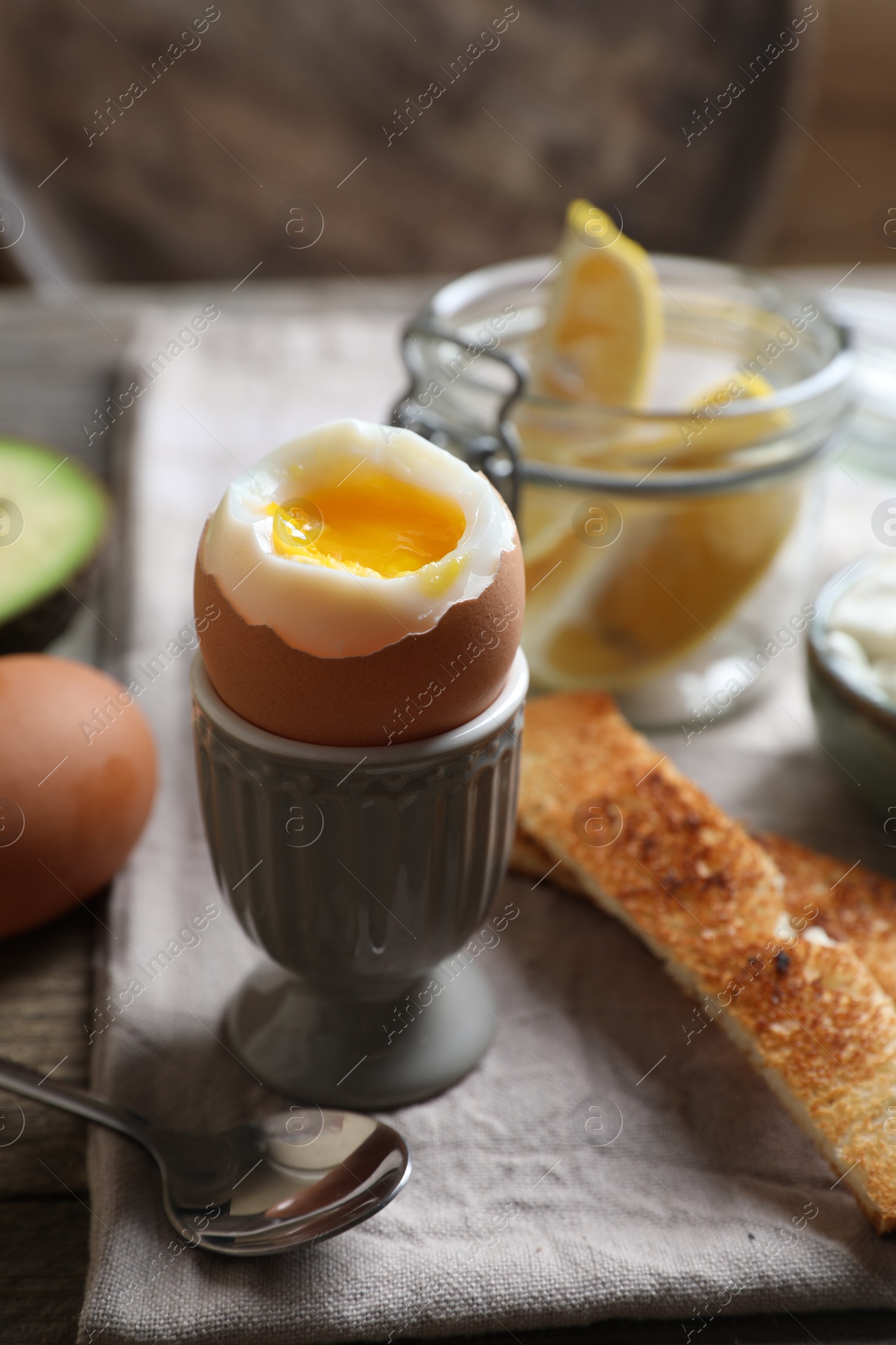 Photo of Soft boiled egg served for breakfast on wooden table