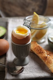 Soft boiled egg served for breakfast on wooden table