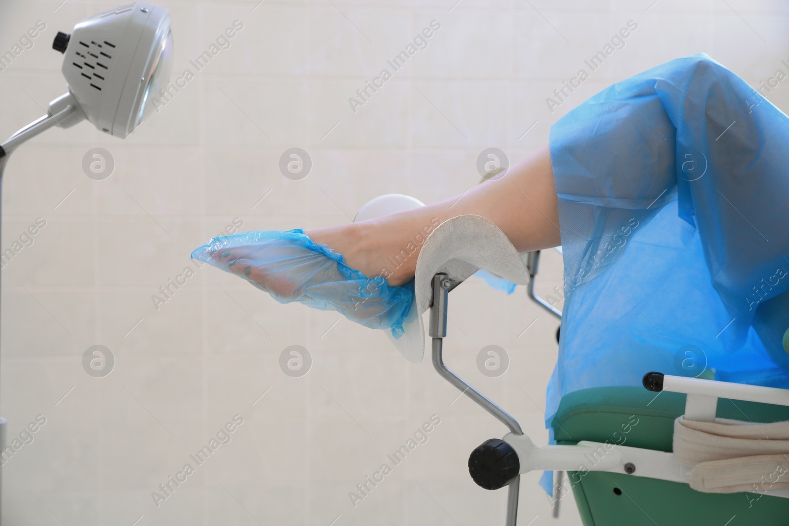 Photo of Gynecological checkup. Woman lying on examination chair in clinic, closeup