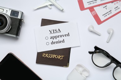 Photo of Composition with passport, toy plane and tickets on white background, top view. Visa receiving