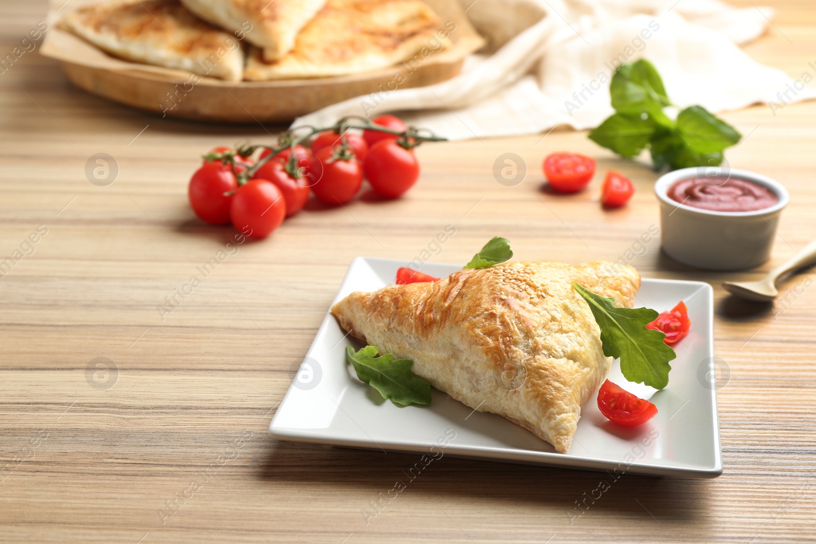 Photo of Fresh delicious puff pastry served on wooden table