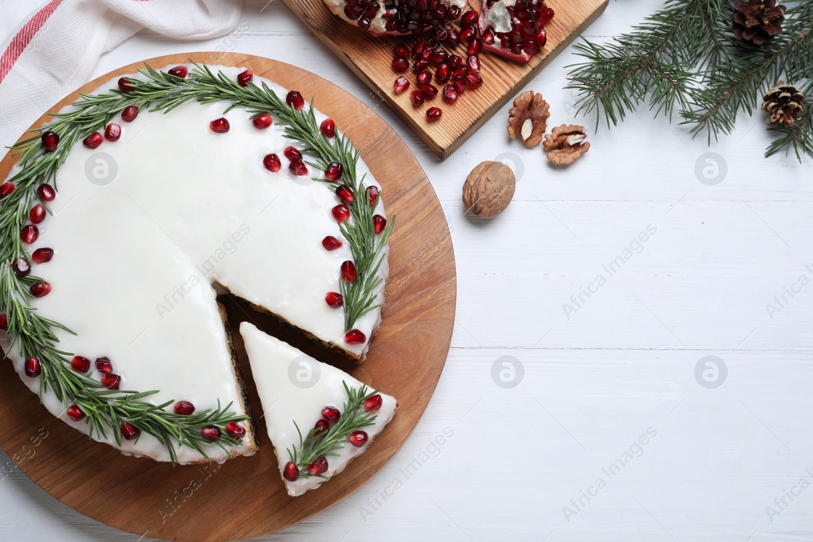 Photo of Flat lay composition with traditional Christmas cake on white wooden table. Space for text