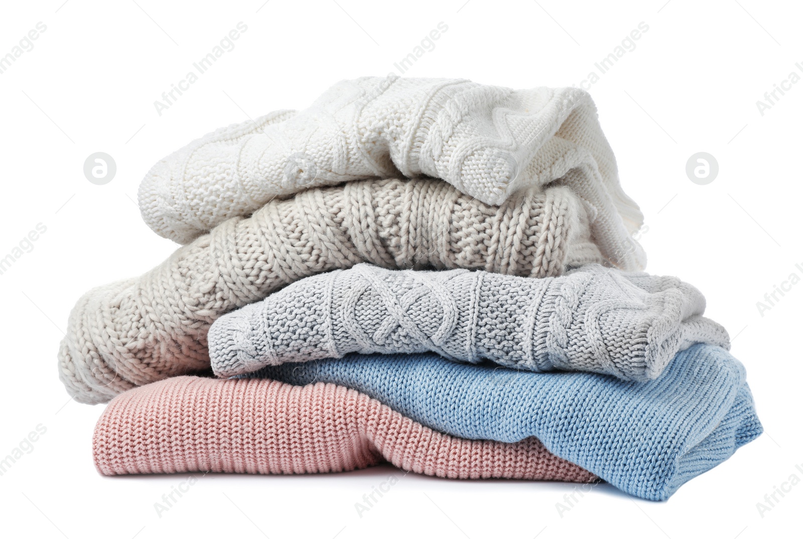 Photo of Stack of folded knitted sweaters on white background