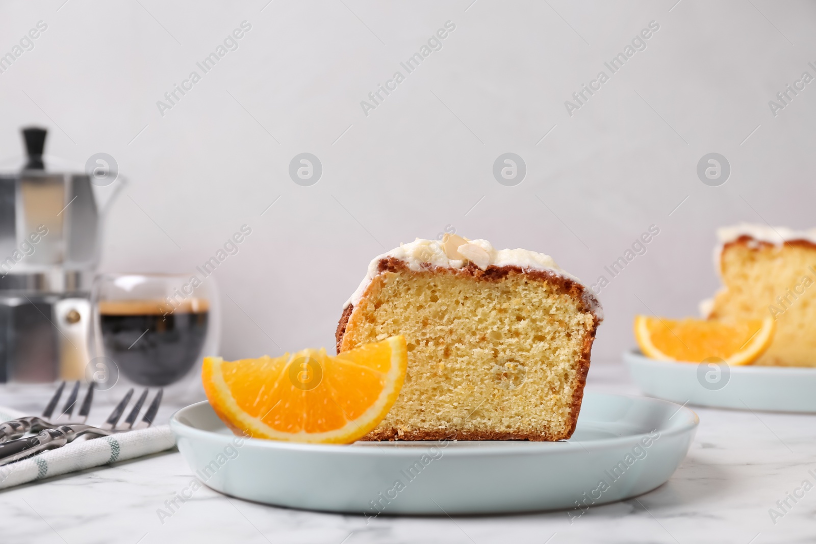 Photo of Cut delicious sweet cake on white marble table