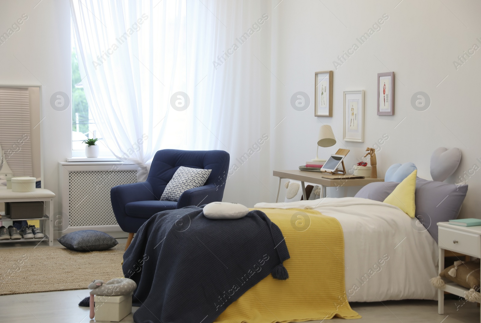 Photo of Modern teenager's room interior with bed and armchair