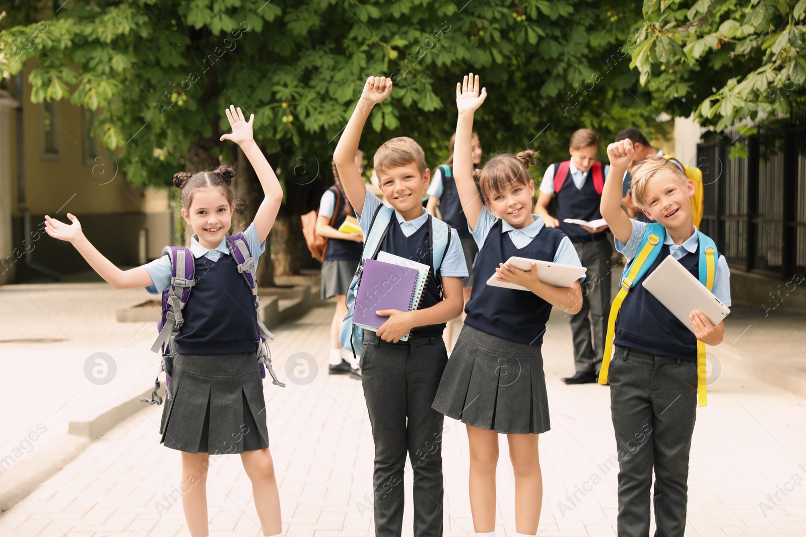 Photo of Little children in stylish school uniform outdoors