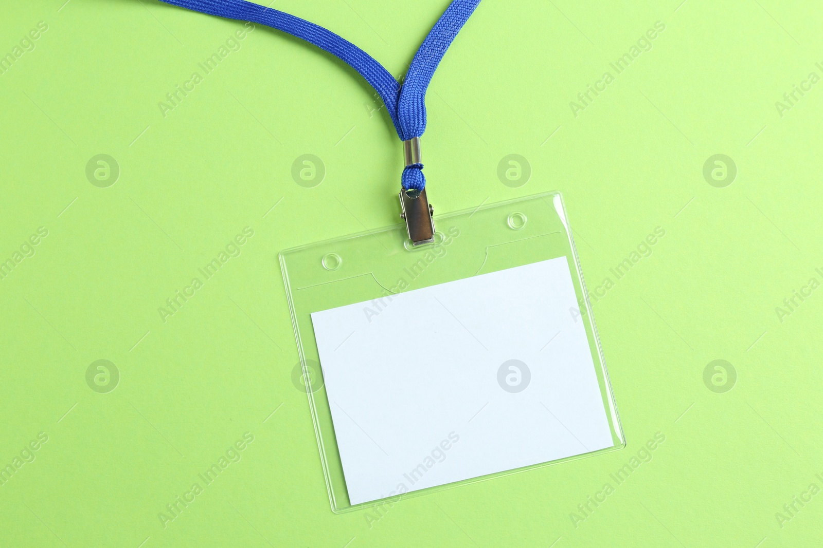 Photo of Blank badge on green background, top view. Mockup for design