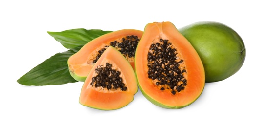 Fresh ripe papaya fruits with green leaves on white background