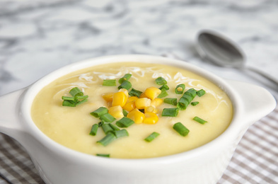 Delicious corn cream soup in bowl, closeup