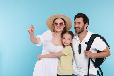 Photo of Happy family on light blue background, space for text