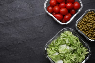 Photo of Glass containers with different fresh products on black table, flat lay. Space for text