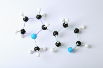 Photo of Molecule of nicotine on white background, top view. Chemical model