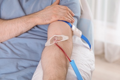 Man donating blood to save someone's life in hospital