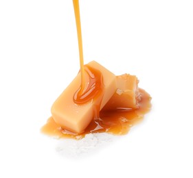 Pouring delicious salted caramel on candies isolated on white