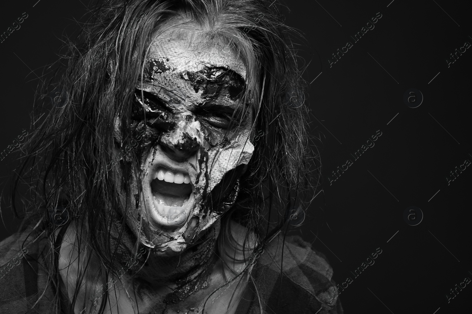 Photo of Scary zombie on dark background, black and white effect. Halloween monster