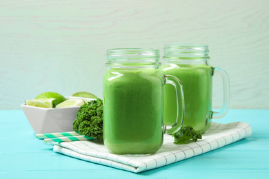 Photo of Tasty fresh kale smoothie on light blue wooden table