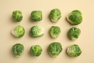 Photo of Fresh Brussels sprouts on beige background, flat lay