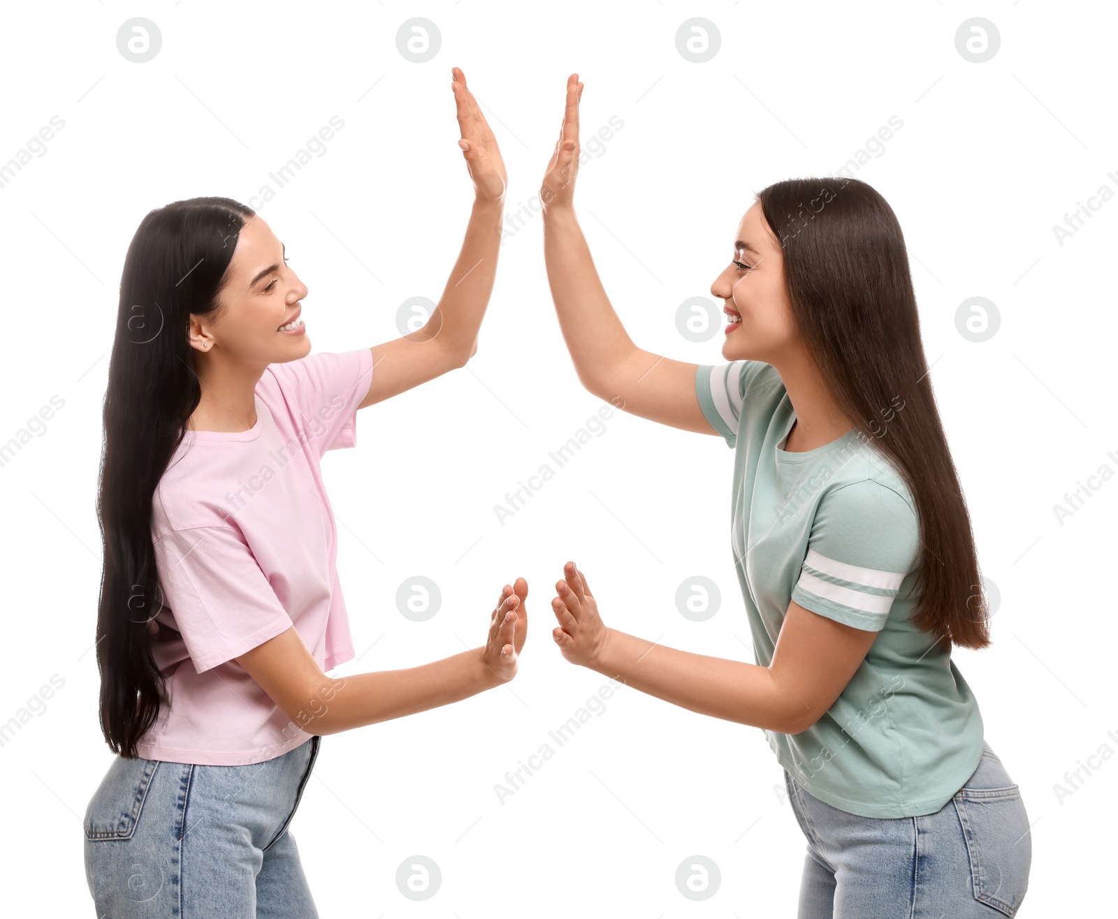 Photo of Women giving high five on white background