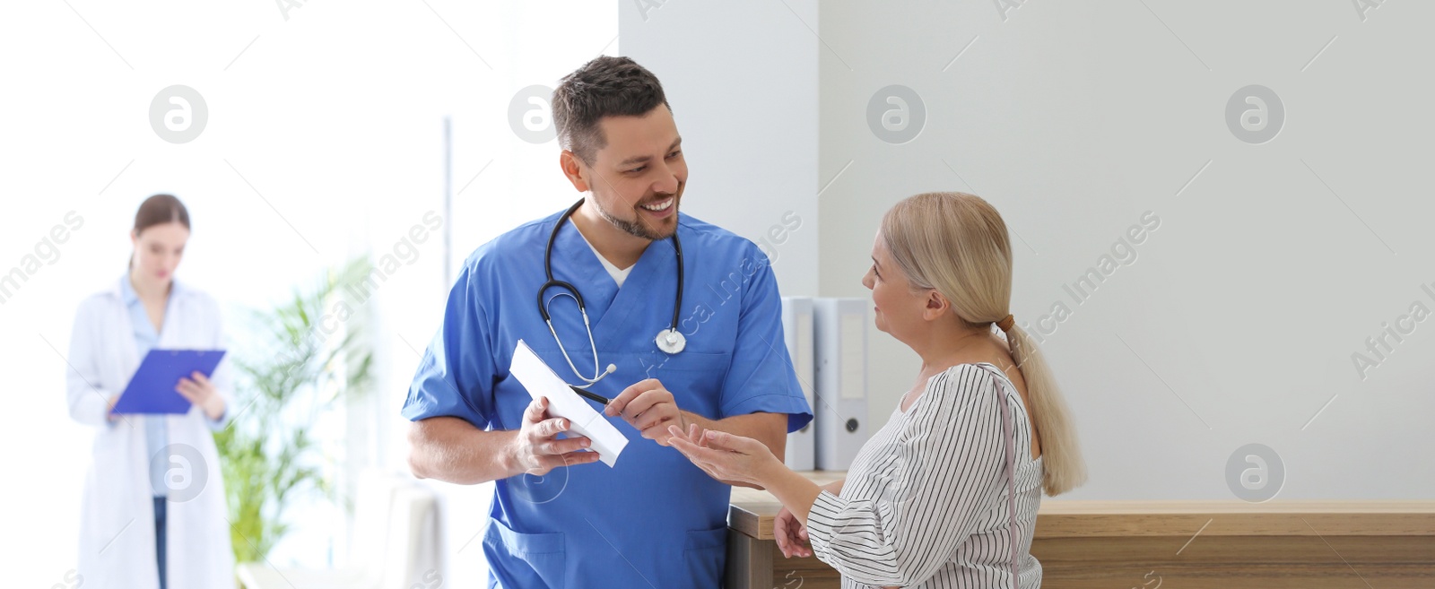 Image of Doctor talking with patient in hospital hall. Banner design