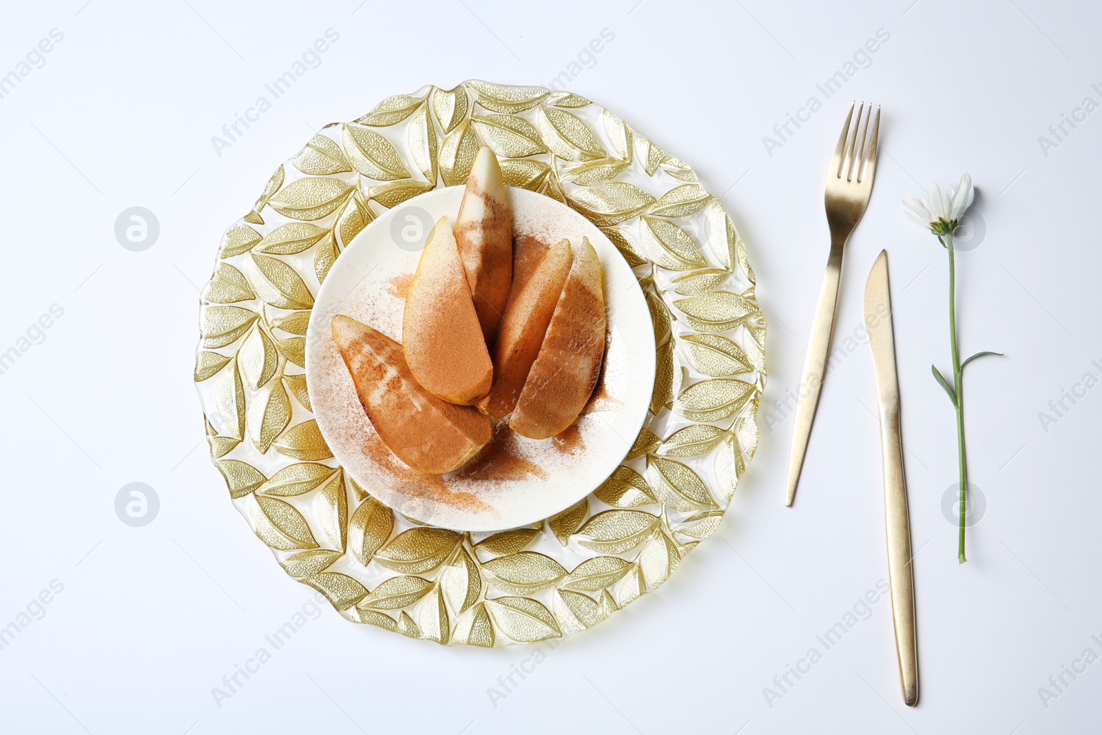 Photo of Flat lay composition with plate of sliced pears and cinnamon on white background