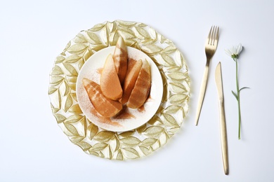 Photo of Flat lay composition with plate of sliced pears and cinnamon on white background