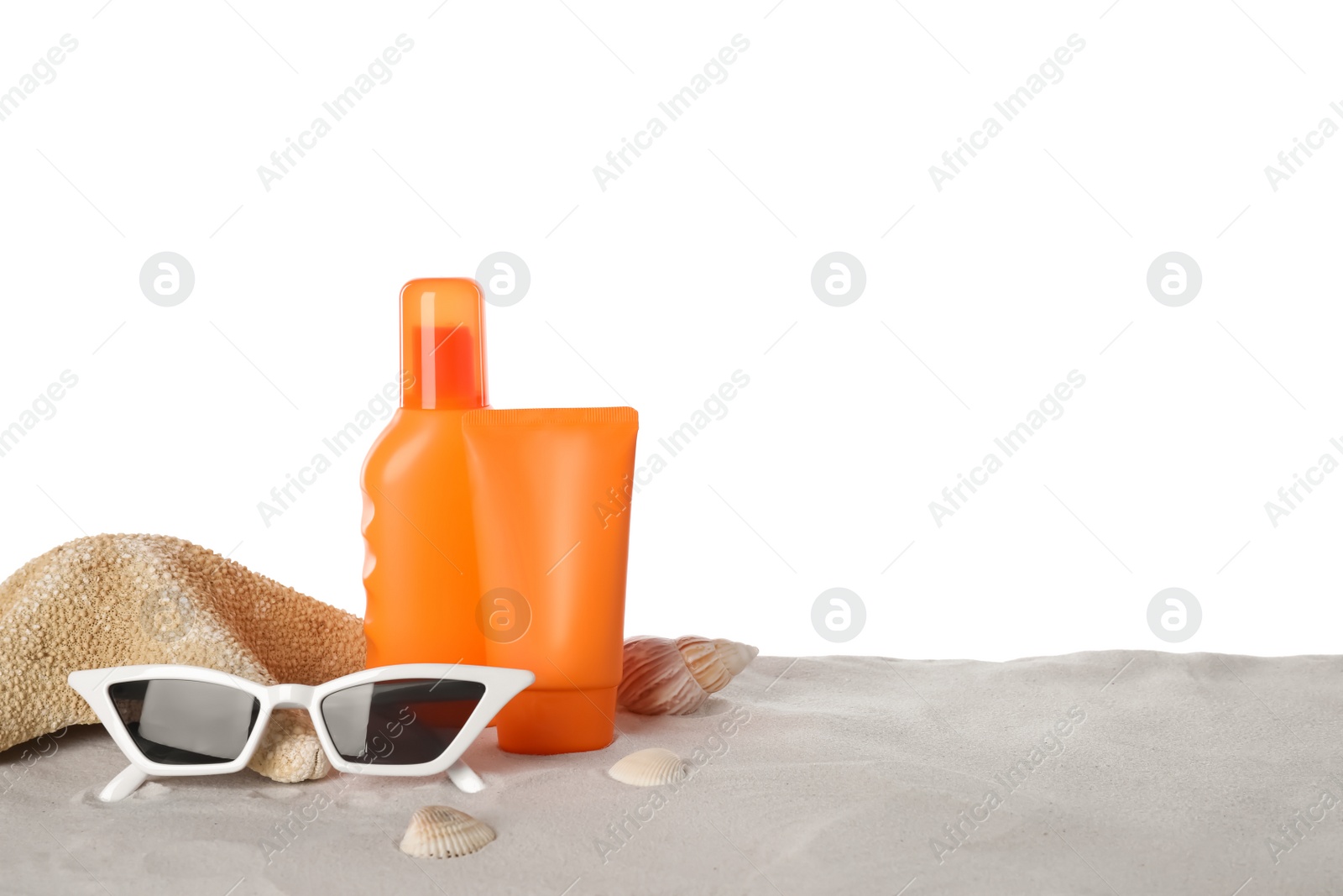 Photo of Composition with sun protection products on sand against white background. Space for text