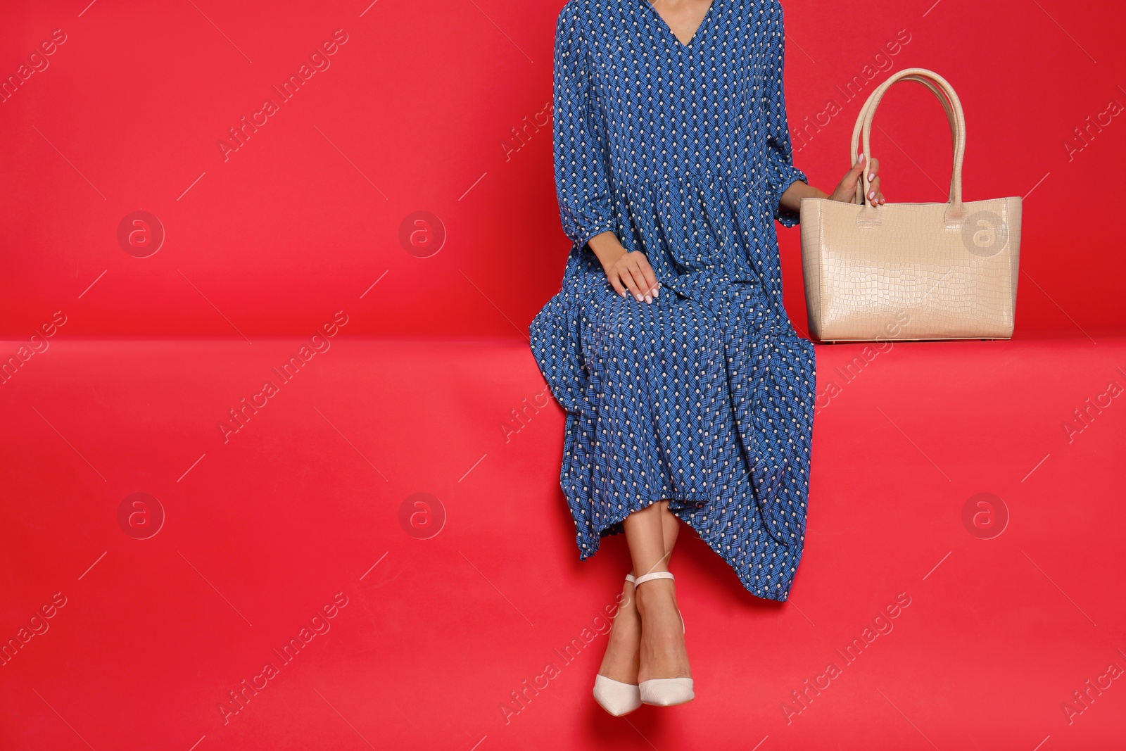 Photo of Woman with stylish bag on red background, closeup. Space for text