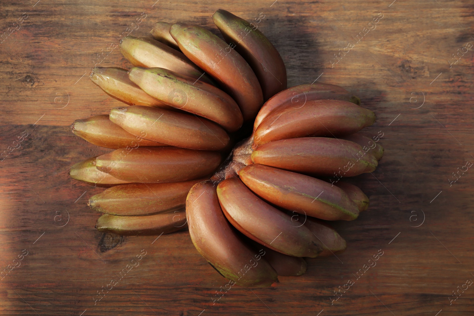 Photo of Tasty purple bananas on wooden table, top view