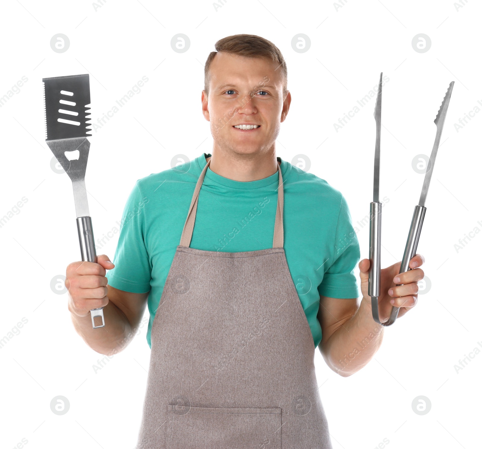 Photo of Man in apron with barbecue utensils on white background