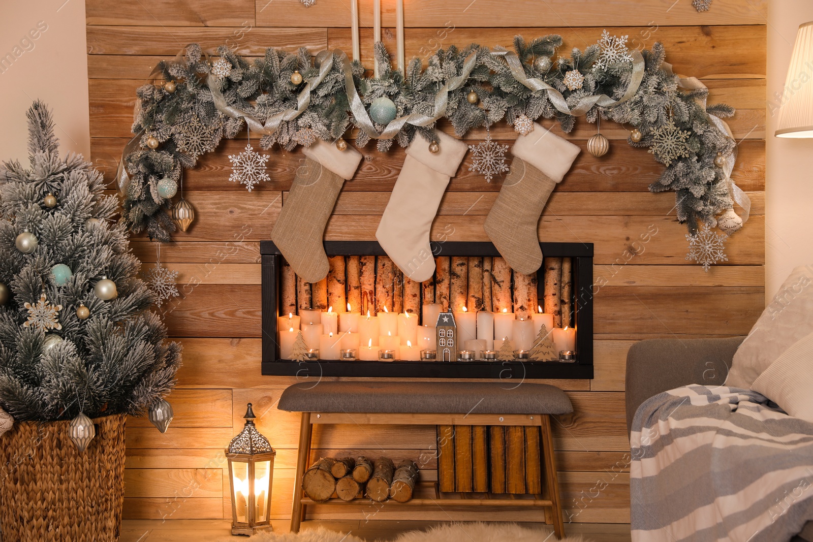 Photo of Festive room interior with decorative fireplace and Christmas stockings